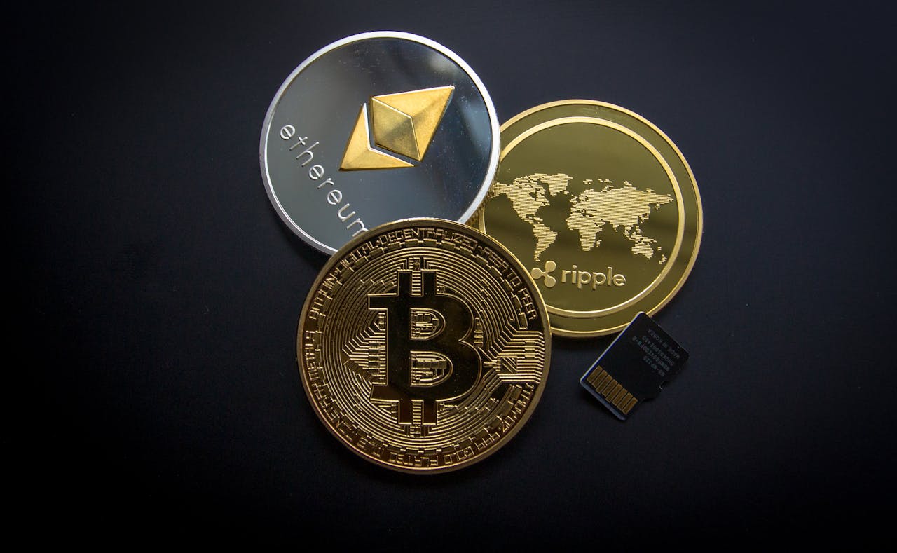 about-us A striking image of Bitcoin, Ethereum, and Ripple coins illustrating modern digital currency.